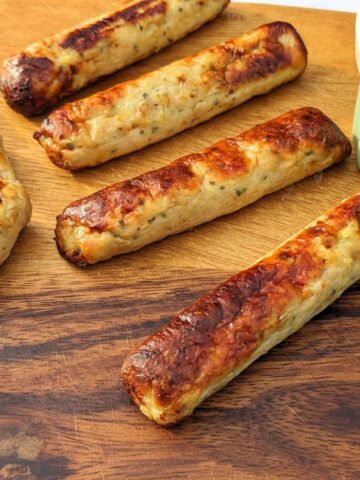 Air fried chicken sausages on a board.