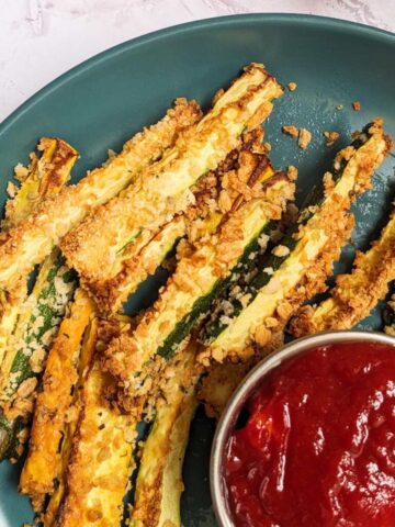 Zucchini Fries on a plate with a tomato dip
