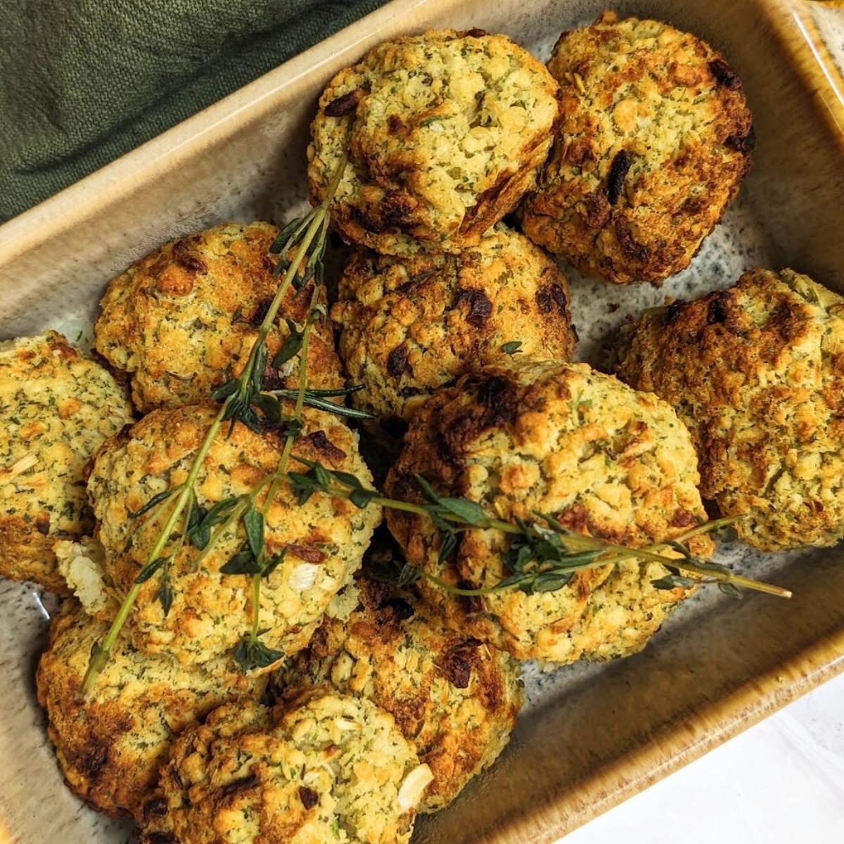 A serving dish with a pile of air fried stuffing balls topped with fresh herbs.