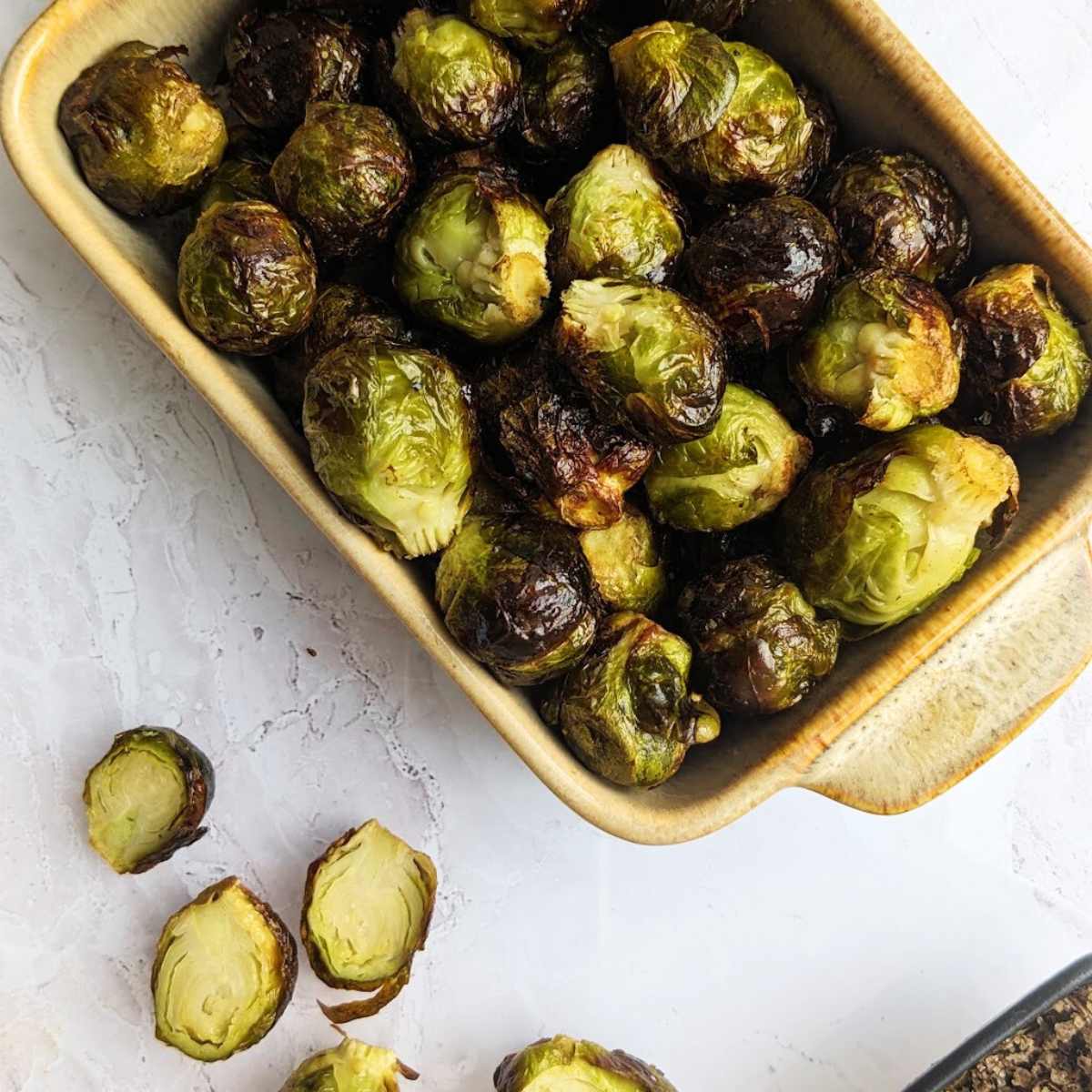Air fryer frozen Brussels sprouts in a serving dish.